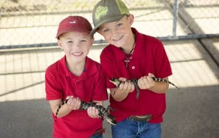 kids holding baby gators